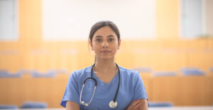 nursing student stands in classroom
